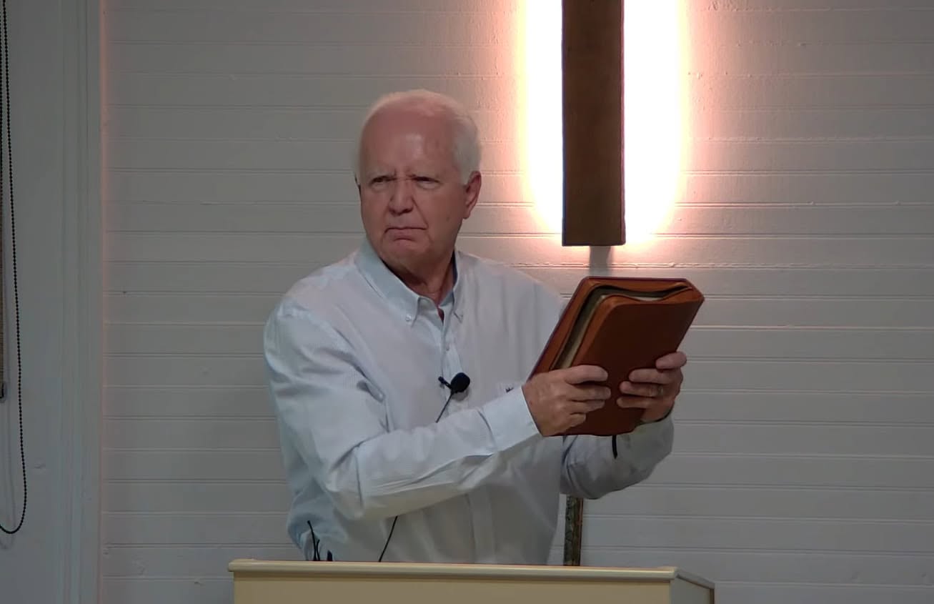 Pastor Wayne Holcomb preaching from the Bible